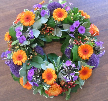 Purple and Orange round funeral wreath 