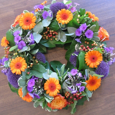 Purple and Orange round funeral wreath 