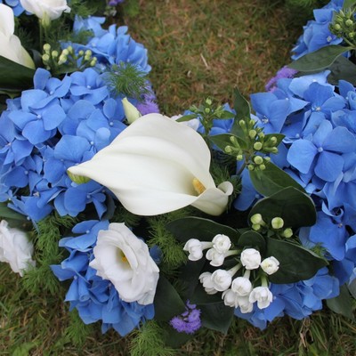 blue and white funeral wreath