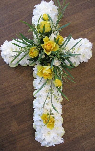 yellow and white based funeral cross