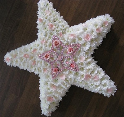 star shaped funeral flower tribute