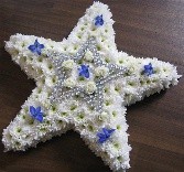 star shaped funeral flower tribute