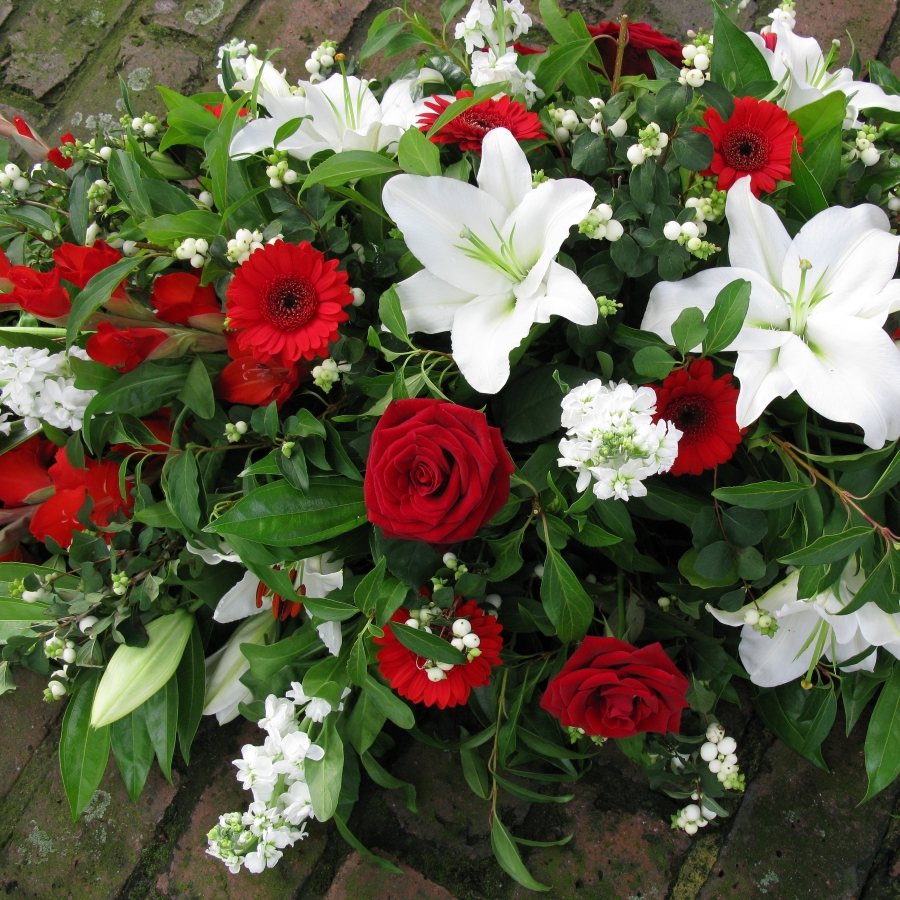 Seasonal Red Rose funeral coffin spray