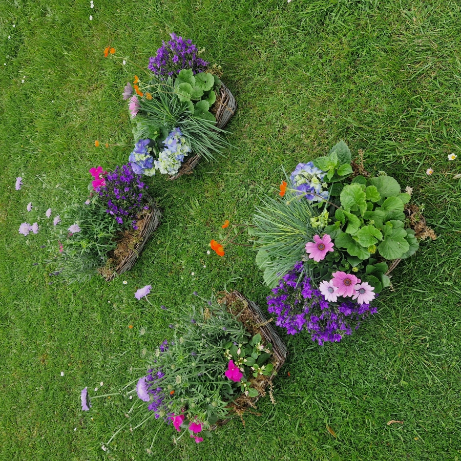 	Planted hearse baskets filled with seasonal plants, placed beside the coffin for an eco‑friendly funeral tribute.