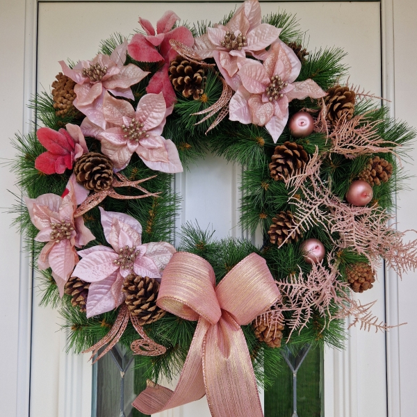 Faux pink poinsettia Christmas wreath with rose gold shimmer, faux apples, pine cones, and a 50cm faux pine base