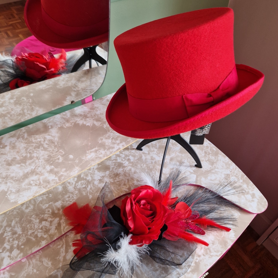 Alternative wedding top hat in red wool with removable floral detail.
