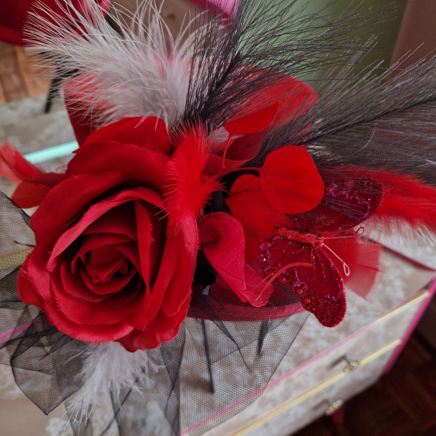 Alternative wedding top hat in red wool with removable floral detail.