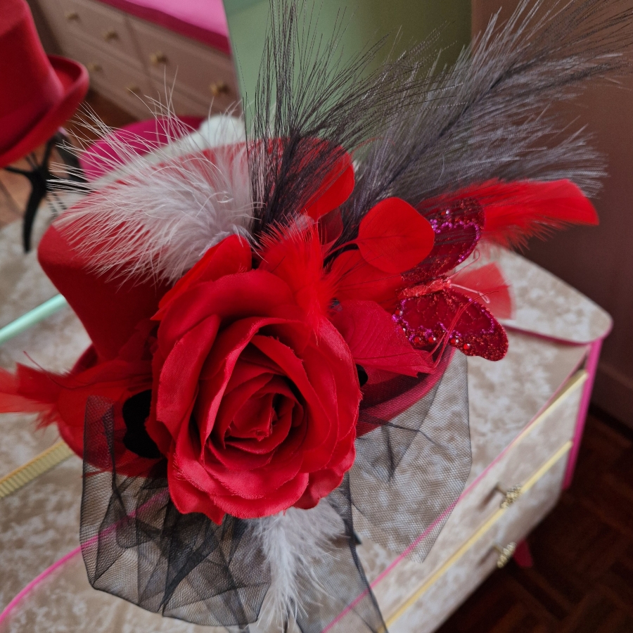 Alternative wedding top hat in red wool with removable floral detail.