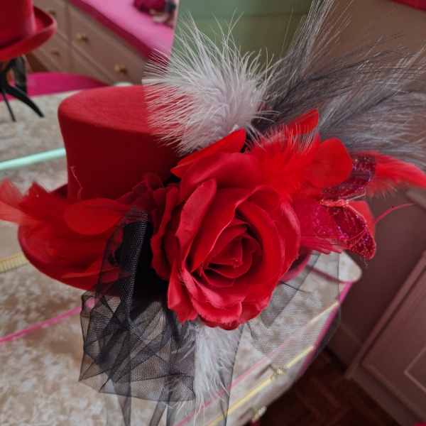 Alternative wedding top hat in red wool with removable floral detail.