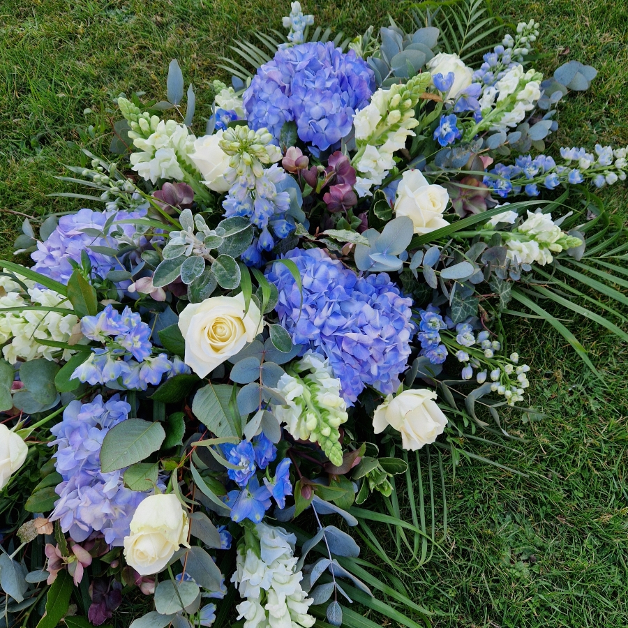 Seasonal blue and white coffin spray