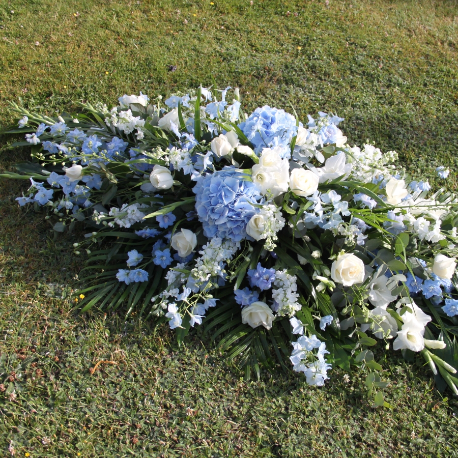 Seasonal blue and white coffin spray