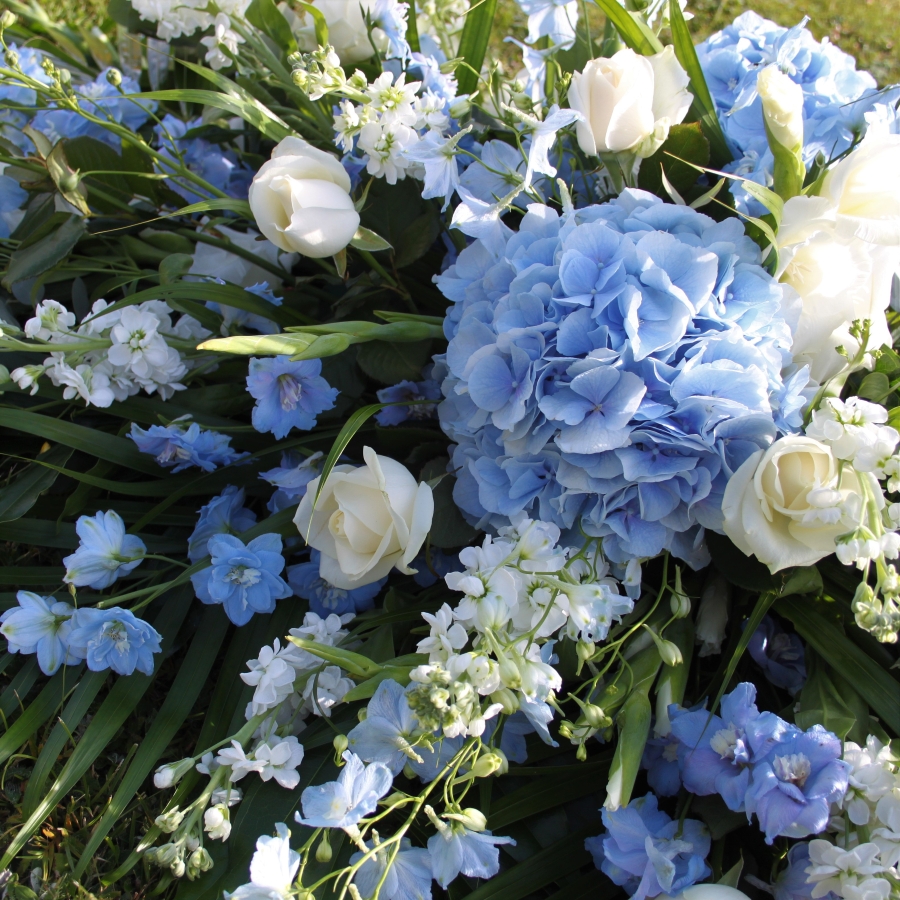 Seasonal blue and white coffin spray