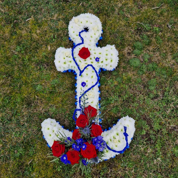 Bespoke funeral tribute in the shape of an anchor in red, white and blue