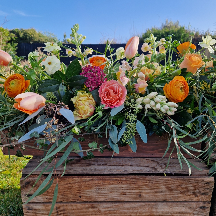 Coffin meadow box design, seasonal flowers in apricot tones