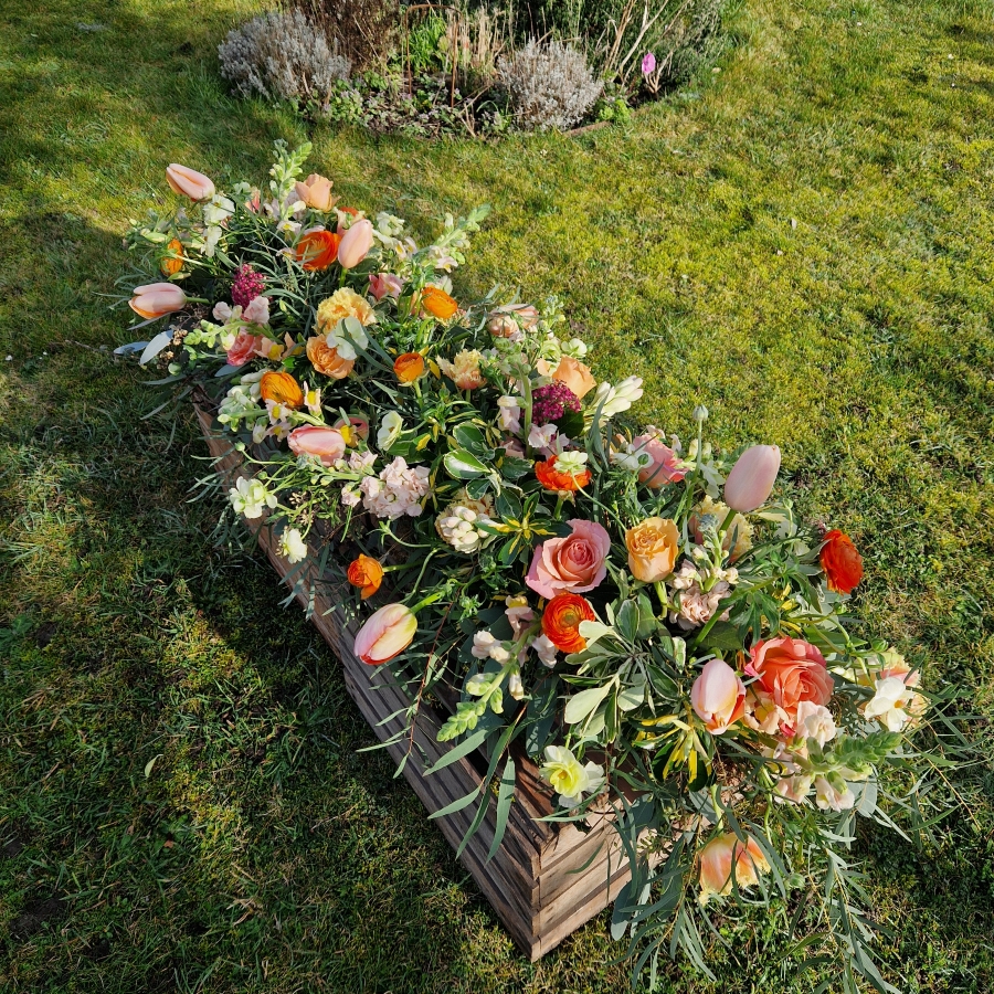 Coffin meadow box design, seasonal flowers in apricot tones
