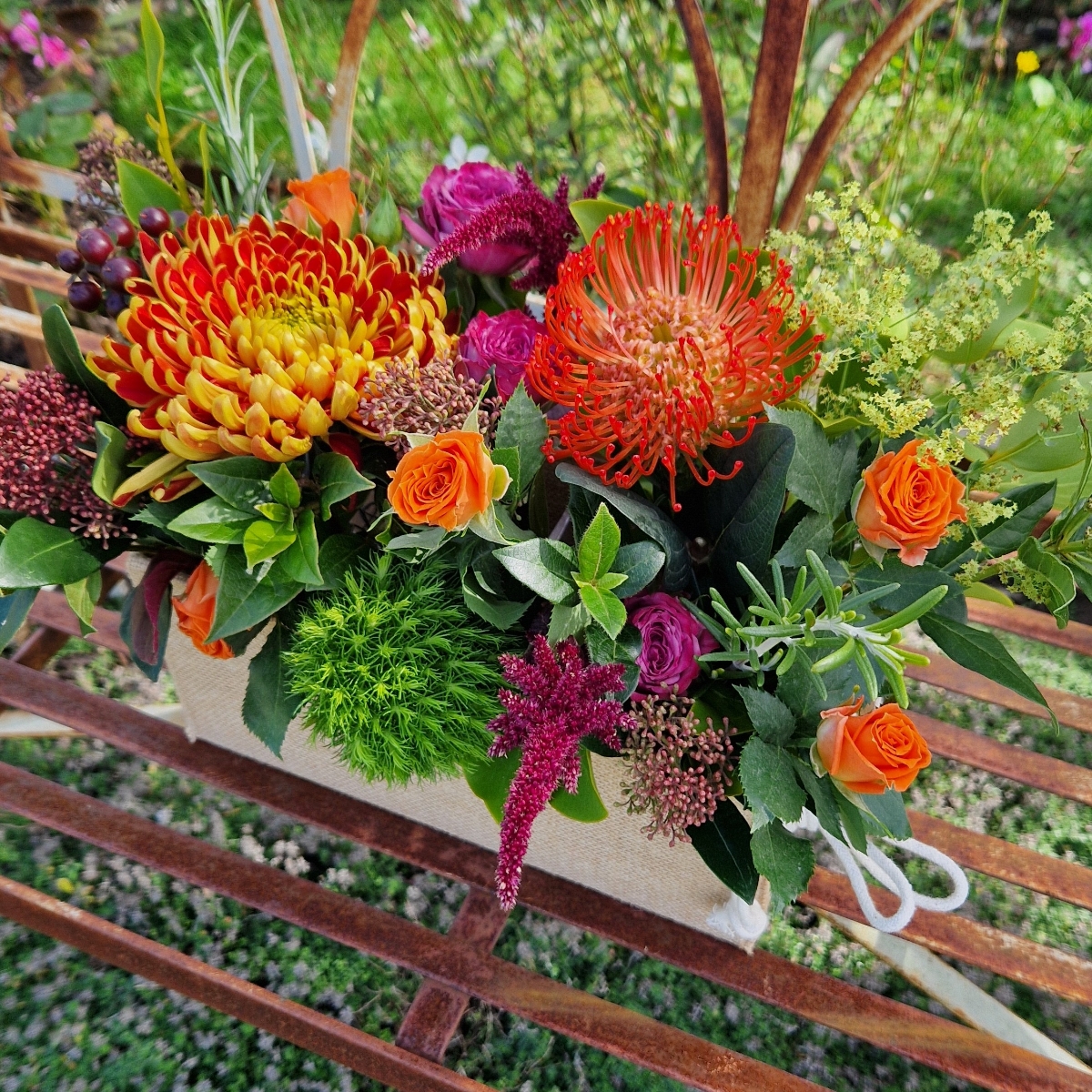 Autumn Downs jute trough arrangement with rust chrysanthemums, roses, seasonal berries and grasses
