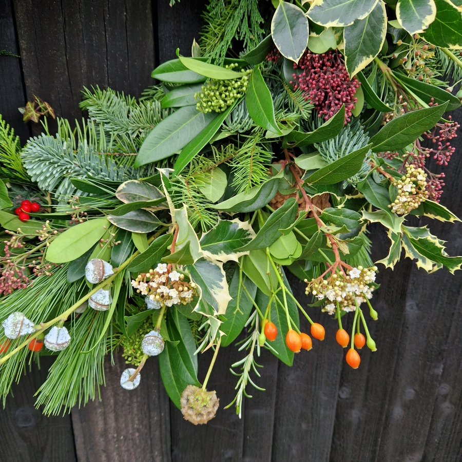 Biodegradable funeral wreath made with seasonal foliage on a mossed base.