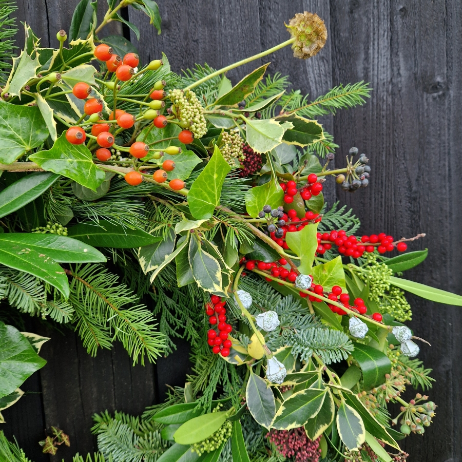 Biodegradable funeral wreath made with seasonal foliage on a mossed base.