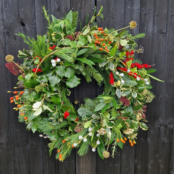 Biodegradable funeral wreath made with seasonal foliage on a mossed base.