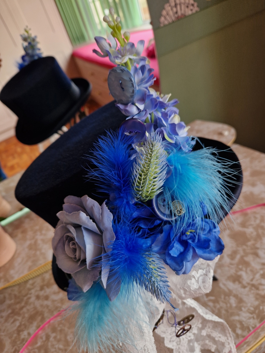 Navy wool top hat with structured crown and detachable faux flowers, or Goggles ideal for weddings or steampunk events.