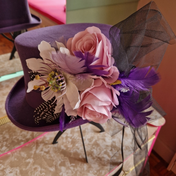 Alternative wedding top hat in purple wool with removable floral detail.