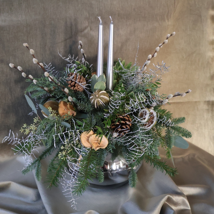 Twinkle Twinkle candle arrangement with silver candles, fresh pine, eucalyptus, dried citrus, and pine cones on a mirrored glass vase.