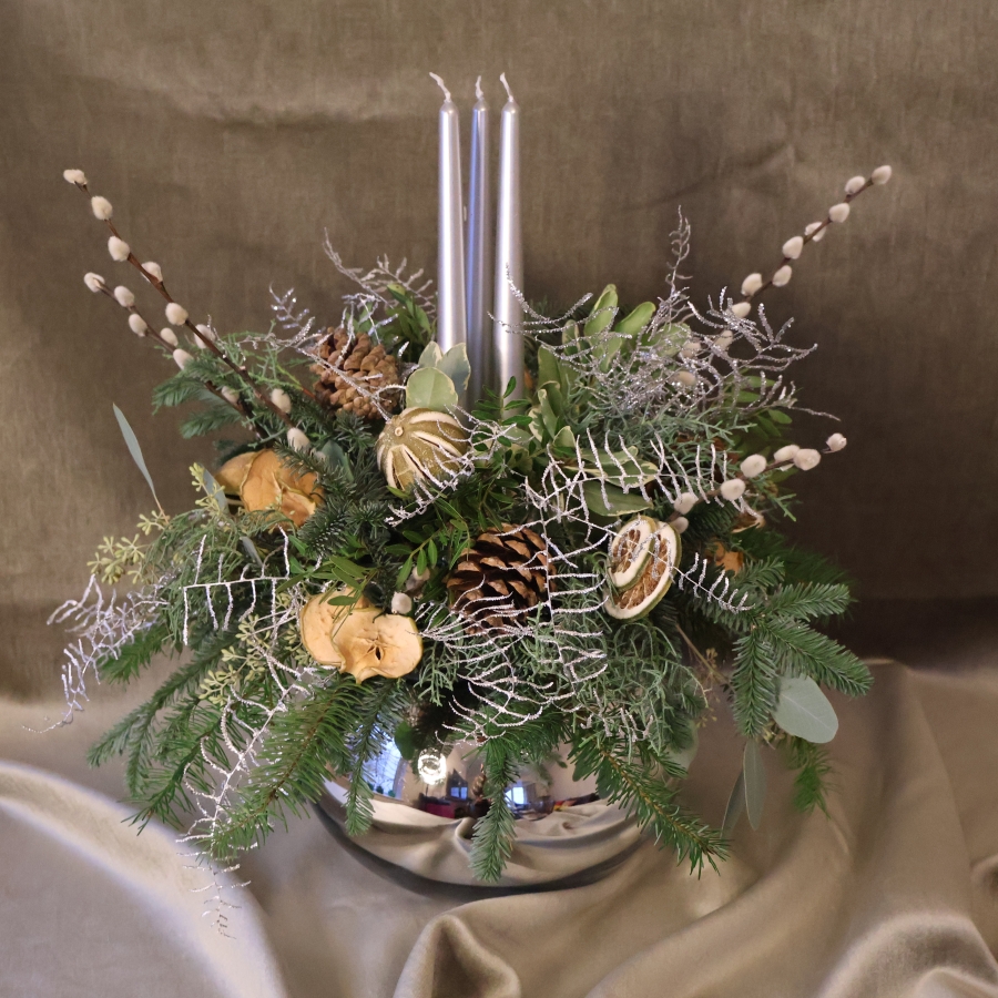 Twinkle Twinkle candle arrangement with silver candles, fresh pine, eucalyptus, dried citrus, and pine cones on a mirrored glass vase.