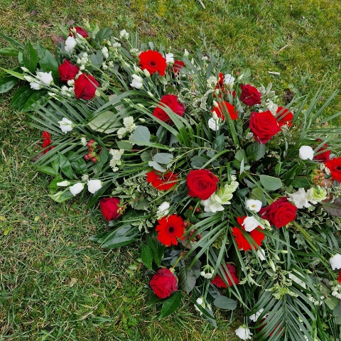 Seasonal Red Rose funeral coffin spray