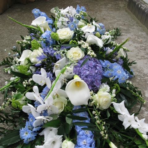 Funeral coffin spray with premium luxury flowers including orchids, hydrangeas, delphiniums