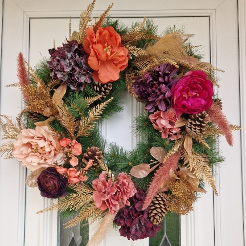 Faux flower Christmas wreath with peonies, hydrangeas, ranunculus, skimmia, pine cones, and gold accents on a 50cm faux pine ring