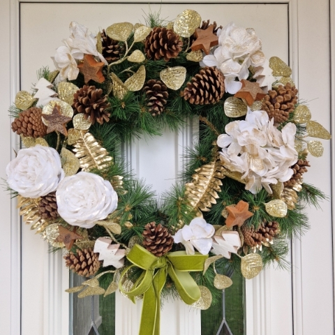 White faux flower Christmas wreath with roses, hydrangeas, gold accents, coco stars, pine cones, and velvet bow on a 50cm faux pine ring
