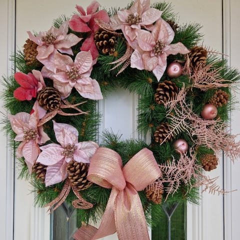 Faux pink poinsettia Christmas wreath with rose gold shimmer, faux apples, pine cones, and a 50cm faux pine base