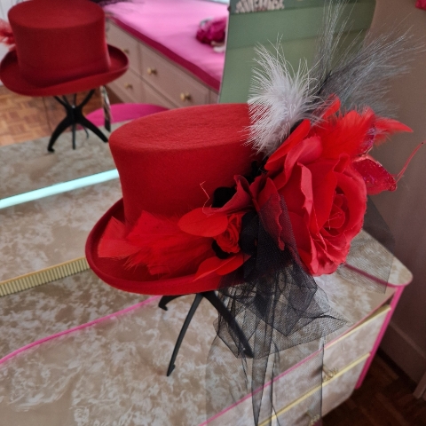 Alternative wedding top hat in red wool with removable floral detail.