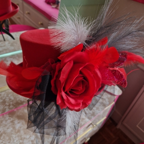 Alternative wedding top hat in red wool with removable floral detail.