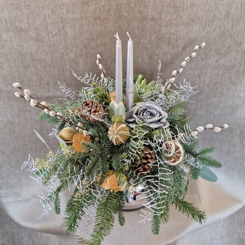 Twinkle Twinkle candle arrangement with silver candles, fresh pine, eucalyptus, dried citrus, and pine cones on a mirrored glass vase.