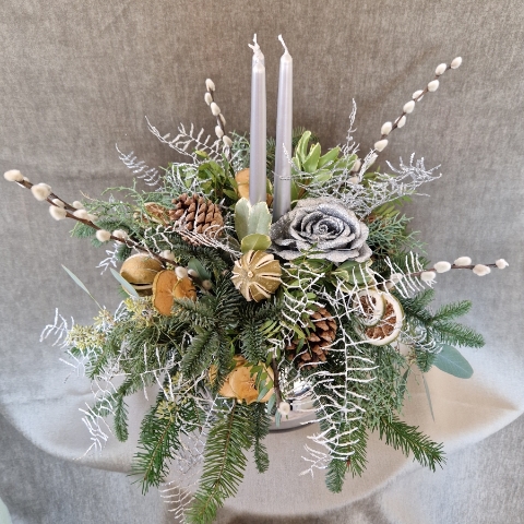 Twinkle Twinkle candle arrangement with silver candles, fresh pine, eucalyptus, dried citrus, and pine cones on a mirrored glass vase.