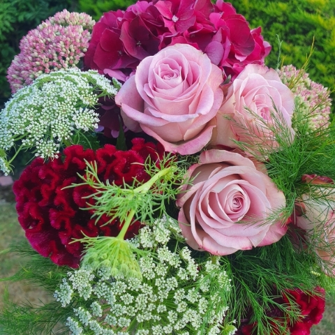 A hand‑tied seasonal bouquet created by the florist, featuring a mix of fresh, romantic blooms tailored to the occasion, such as tulips, ranunculus, astrantia, antirrhinum, and eucalyptus.
