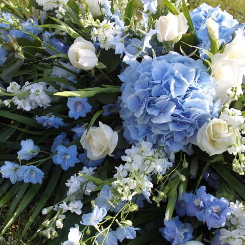 Seasonal blue and white coffin spray