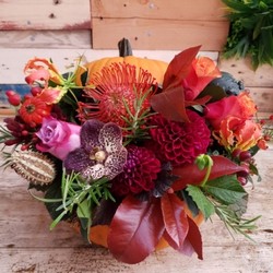 Fresh pumpkin filled with autumn flowers