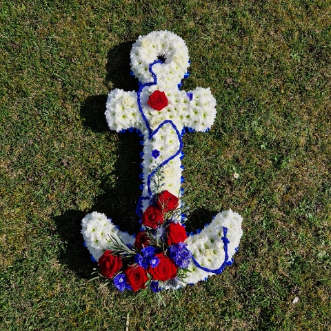 Bespoke funeral tribute in the shape of an anchor in red, white and blue