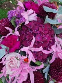Chyngton autumn bouquet in rich pink and plum tones, featuring nerines, chrysanthemum blooms, roses, carnations, and statice in a lush, seasonal arrangement