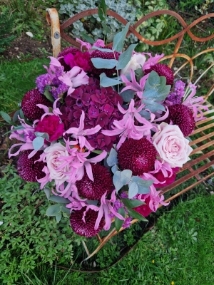 Chyngton autumn bouquet in rich pink and plum tones, featuring nerines, chrysanthemum blooms, roses, carnations, and statice in a lush, seasonal arrangement