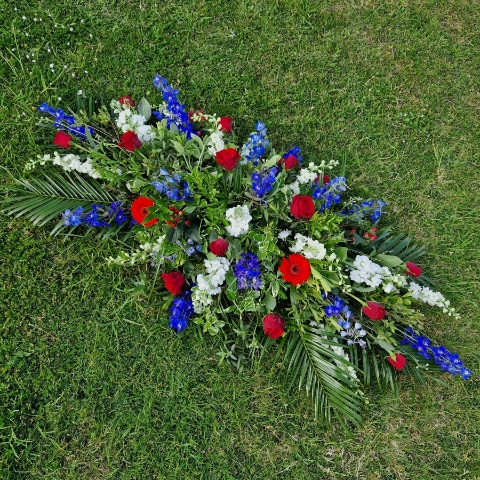 Seasonal coffin spray in red, white and blue flowers