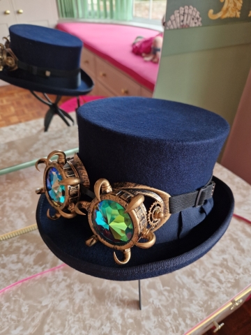 Navy wool top hat with structured crown and detachable faux flowers, or Goggles ideal for weddings or steampunk events.