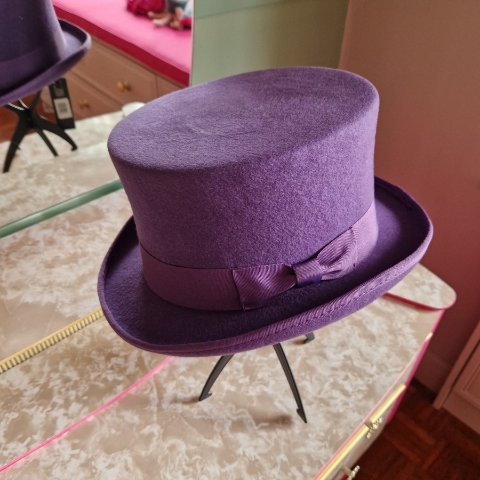 Alternative wedding top hat in purple wool with removable floral detail.